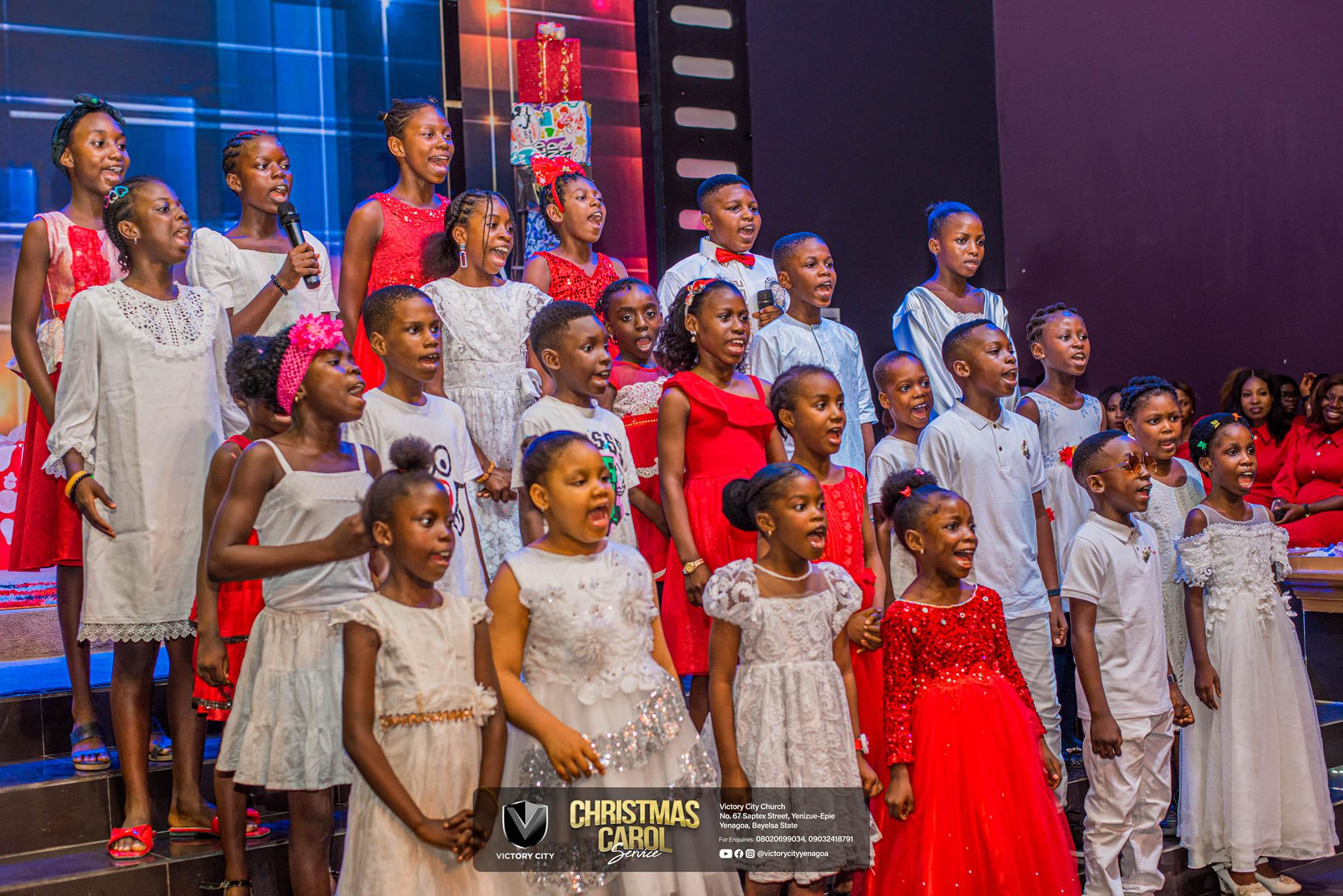 Children singing together during a Victory City service